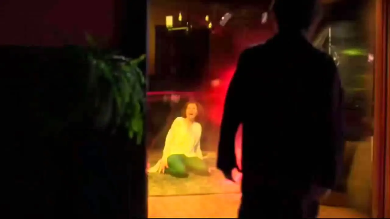 The night of Nora Allen’s murder: she kneels screaming inside a whirl of red and yellow lightning while a figure stands silhouetted in the doorway.