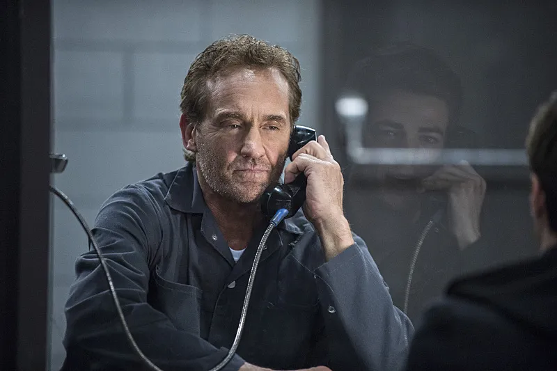 Barry’s father, Henry Allen, in prison, talking to his son on the visiting-room phone through the glass.